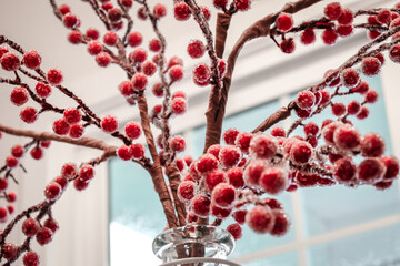 Artificial plant with red round flowers. Plant in the house. Red plant. Red artificial flowers.