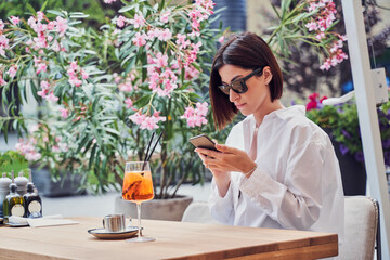 Attractive girl drinking aperol