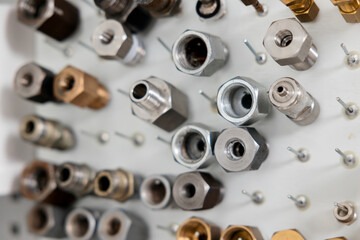 A set of nuts, bolts, connectors, adapters, unions, fittings for testing equipment in a metrology...