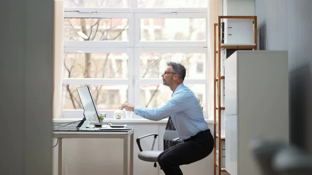 Male Doing Office Yoga Exercise Sit Up And Stretch