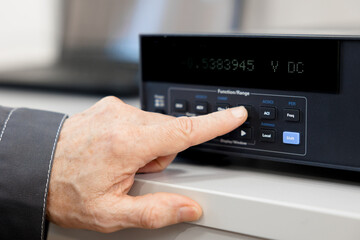 Working equipment of the specialist of the laboratory of metrology and standardization. Measuring instruments digital multimeter and electrical probes.