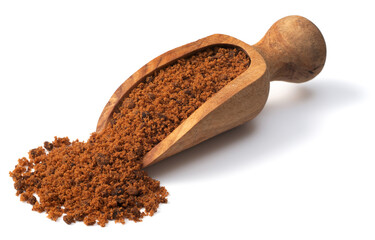 brown granulated sugar in the wooden scoop, isolated on pure white background
