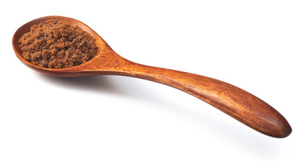 brown sugar in the wooden spoon, isolated on white background