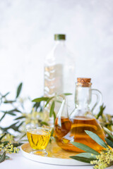 Olive branch and olive oil bottle isolated on white.