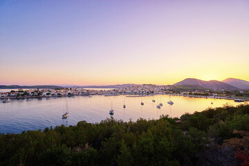 Fototapeta premium Travel by Greece. Beautiful view of Ermioni sea lagoon with moored yachts at sunset time.