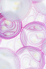 Background of red onion rings lying next to each other isolated on white background