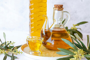 Olive branch and olive oil bottle isolated on white.