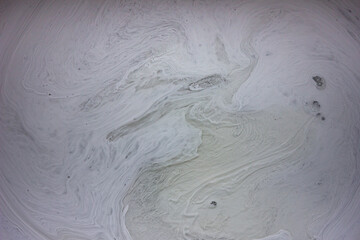 Streaks of gray paint in the bucket. Contemporary art.