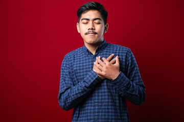 Handsome young man wearing casual clothes smiling with hands on chest with closed eyes and grateful gesture on face