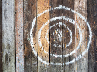 Old boards with a target painted in white paint. Antique stylized target for archery or knife...
