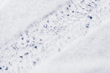 Trace of car tire in the fresh snow. Close up view from above