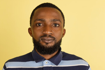 Obraz premium African man's portrait isolated over yellow studio background with copyspace for ad