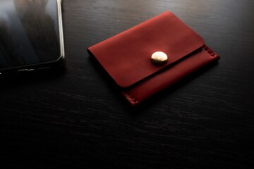 Red leather wallet on a dark background 