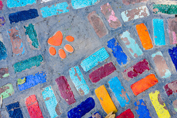 Top view on pieces of multicolored ceramic tiles decorated in garden. Old pavement of tiles textured. Street mosaic cobblestone sidewalk. Abstract,background and pattern of ceramic tile on the floor.