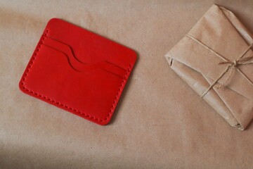 Leather wallet with a package wrapped in kraft paper 