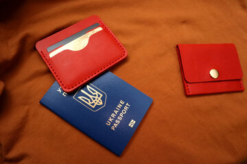Leather wallets and passport on a brown background