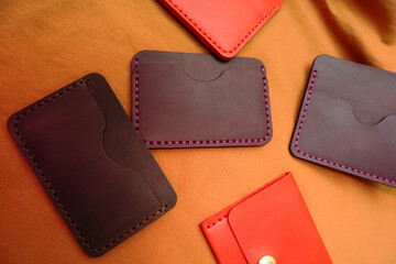 Handmade leather cardholders on a brown background