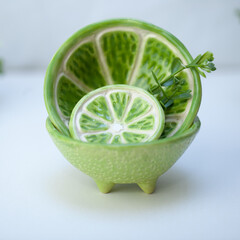 Ceramic cup in the form of half a lime.