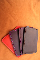Handmade leather cardholders on a brown background