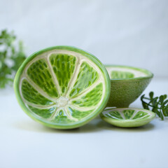Ceramic cup in the form of half a lime.