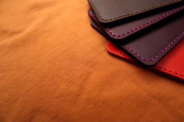 Handmade leather cardholders on a brown background