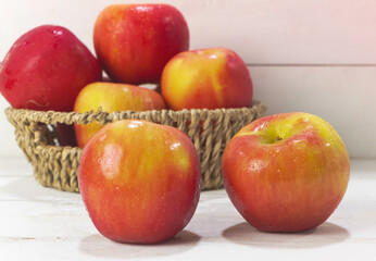 Two apples with water drops put on wooden board,
