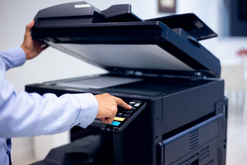 Bussiness man Hand press button on panel of printer, printer scanner laser in office copy machine...