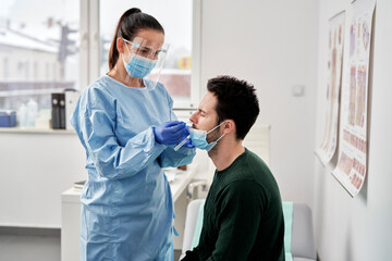 Female doctor taking sample for coronavirus testing, Poland, podkarpackie, Dƒôbica