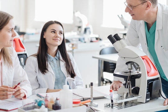 Students and teacher talking in science class