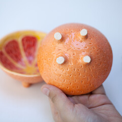 Ceramic cup in the form of half a grapefruit.