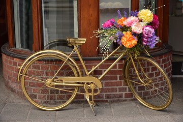Fototapeta na wymiar Decorated Golden bicycle with Colorful Flowers