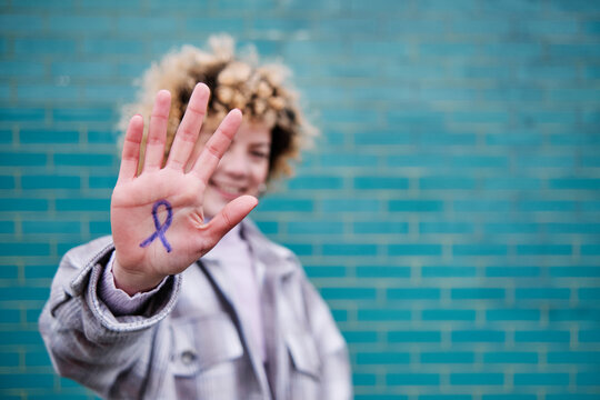 Woman showing sign on palm of hand