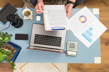 Businessman checking document while working at home