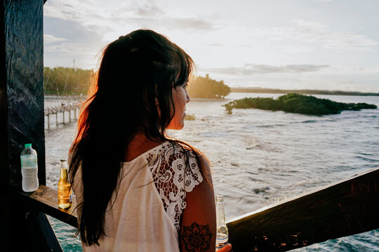 Woman watching the sunset on Siargao Island, Philippines