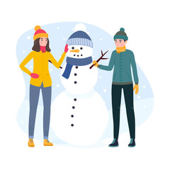 Young couple build a Snowman. Man and woman wearing winter clothes, spend time together