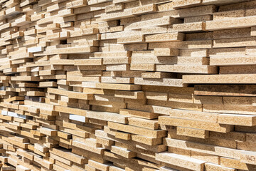 Lumber warehouse. A large stack of chipboard boards is located inside the warehouse.