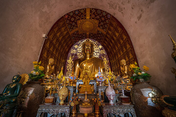 Buddha statue at Wat Chet Yot or Wat Photharam Maha Wihan, seven pagoda temple It is a major tourist attraction in Chiang Mai, Thailand.with evening,Temple in Chiang Mai.