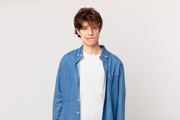 young handsome man looking puzzled and confused