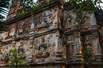 Old Ancient stucco patterns stucco Buddha and angel figures on the outside of the Maha Chedi Wat Chet Yot, seven pagoda temple It is a major tourist attraction in Chiang Mai, Thailand.
