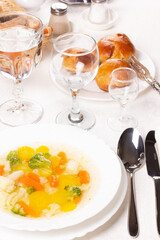 Plate with fresh hot soup on the table and homemade buns