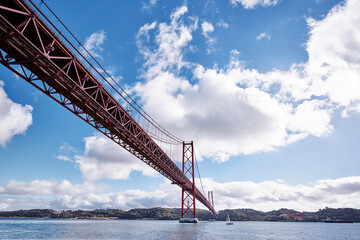 Beautiful landscape with suspension 25 April bridge bridge over the Tagus river in Lisbon, Portugal.