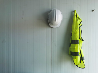 Reflective Vest and white Safety Helmet is Hang on the wall, can input text in left space,