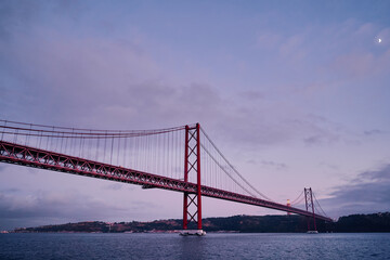 Beautiful landscape with suspension 25 April bridge bridge over the Tagus river in Lisbon, Portugal.