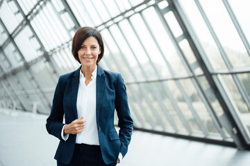 Confident female professional standing in corridor