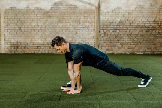 Man doing exercise against wall at health club