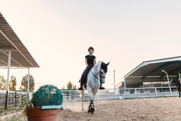Woman riding horse against clear sky during weekend in farm