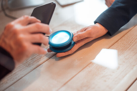 Man scanning bar code reader through smart phone for online payment