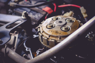 Close-up of motorcycle engine clutch system in maintenance checks.