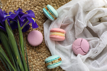 colorful delicious homemade traditional french macarons - elegant french dessert. Natural fruit and berry flavors, creamy stuffing and blue iris flowers on cloth for valentines mother day easter