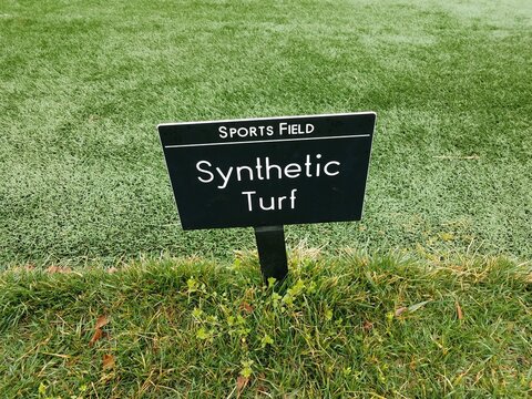 sports field synthetic turf sign on green grass